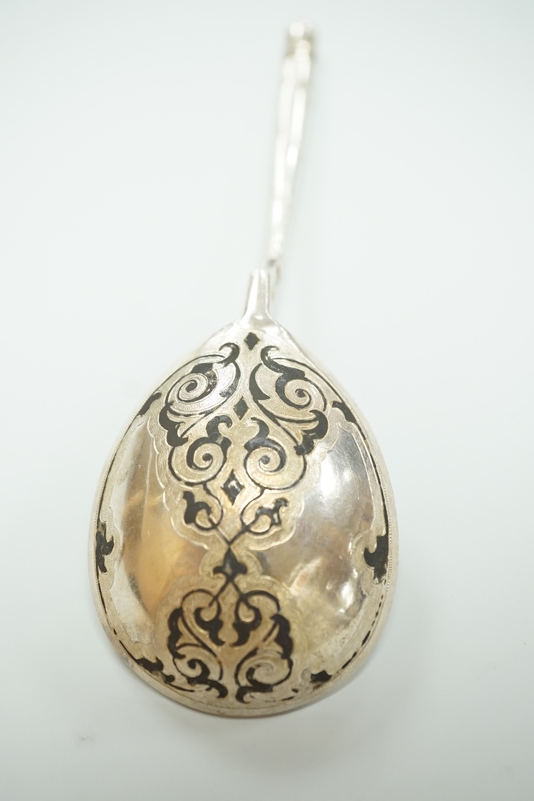 A mid 19th century Russian 84 zolotnik and niello spoon, assay master probably I. Avdyeyev, Moscow, 1857, 18cm.